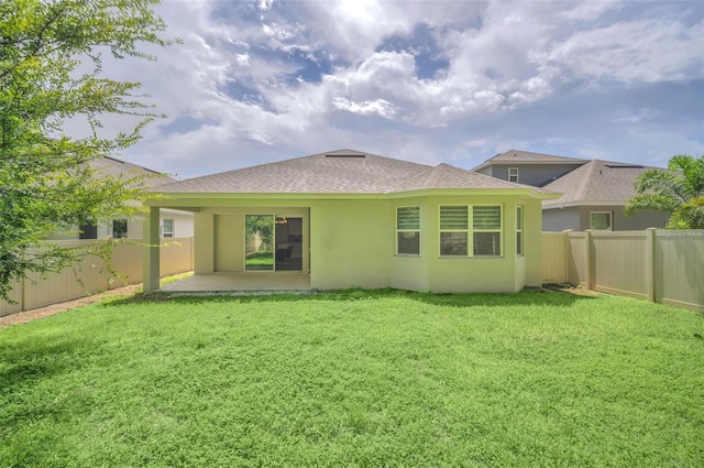 rear view of house with a lawn