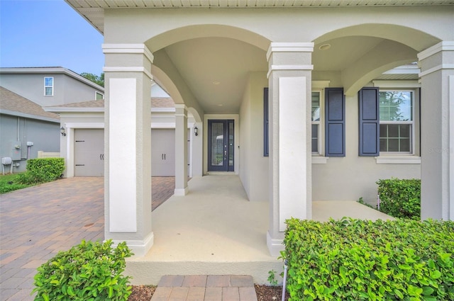 view of exterior entry with a garage