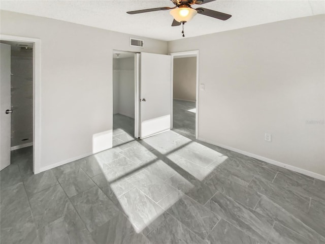 empty room with light tile flooring and ceiling fan