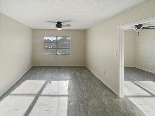 tiled empty room featuring a textured ceiling and ceiling fan