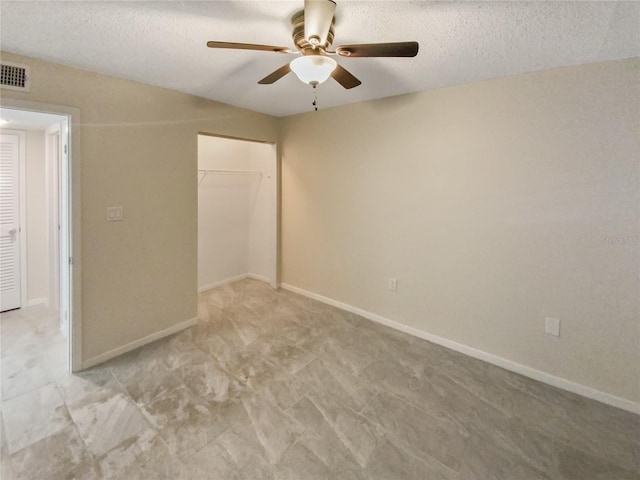 unfurnished bedroom featuring light tile floors, a closet, ceiling fan, and a textured ceiling