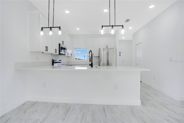 kitchen featuring pendant lighting, light tile floors, appliances with stainless steel finishes, white cabinets, and sink