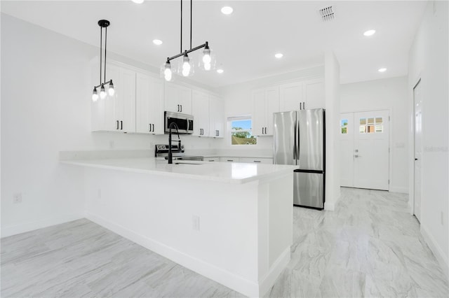 kitchen with kitchen peninsula, pendant lighting, stainless steel appliances, light tile flooring, and white cabinetry