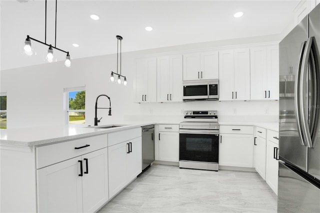 kitchen with light stone countertops, white cabinetry, sink, stainless steel appliances, and pendant lighting