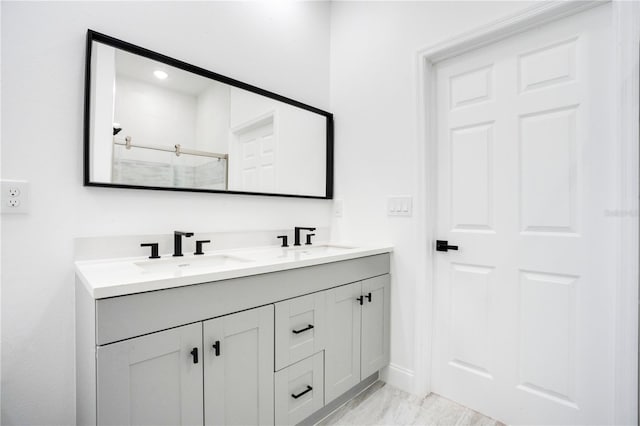 bathroom with double sink vanity and tile flooring