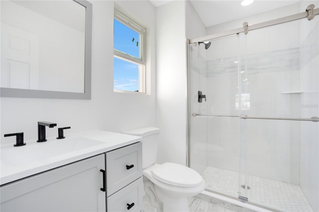 bathroom featuring an enclosed shower, toilet, and vanity with extensive cabinet space