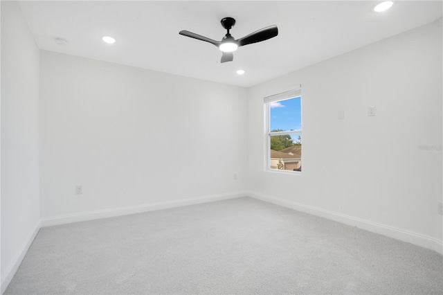 empty room featuring light colored carpet and ceiling fan