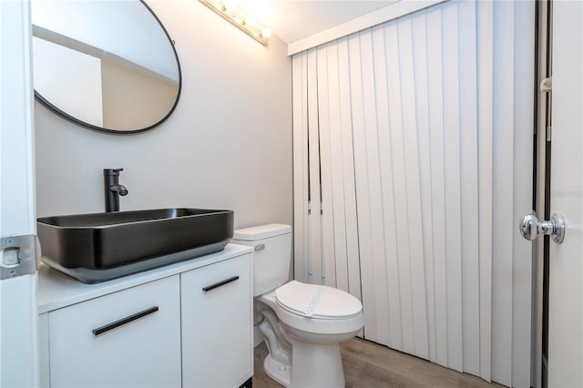 bathroom featuring vanity, toilet, and hardwood / wood-style floors