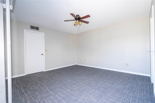 empty room with a textured ceiling and ceiling fan