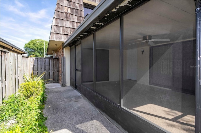 view of side of home featuring ceiling fan