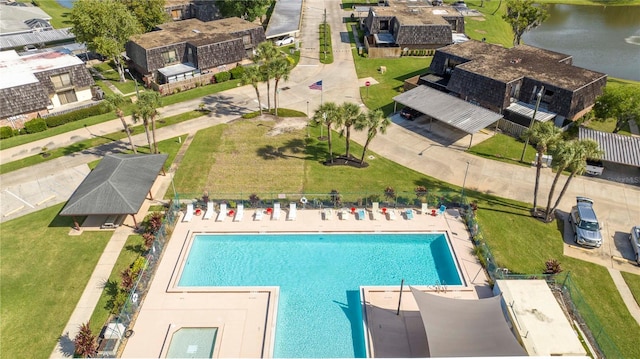 view of pool with a water view and a patio