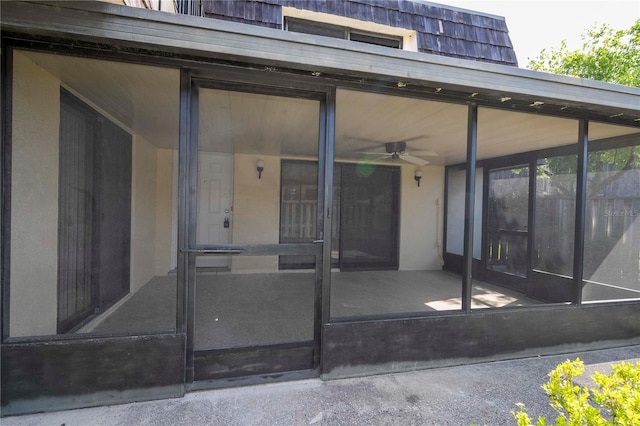 doorway to property featuring ceiling fan