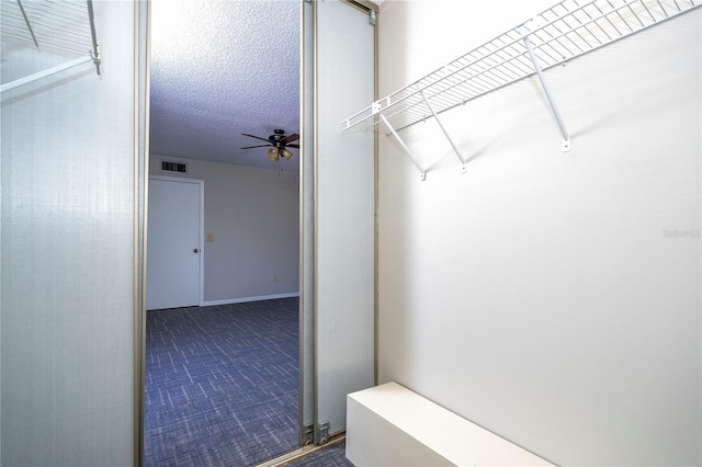 walk in closet featuring ceiling fan