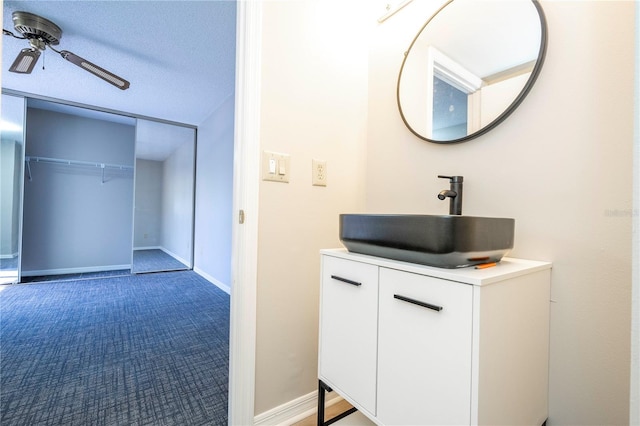 bathroom featuring vanity, a textured ceiling, and ceiling fan