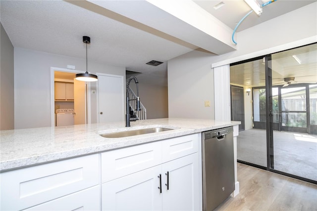 kitchen featuring white cabinets, light hardwood / wood-style floors, independent washer and dryer, sink, and stainless steel dishwasher