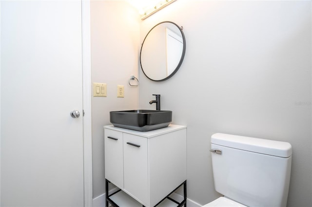 bathroom featuring toilet and vanity