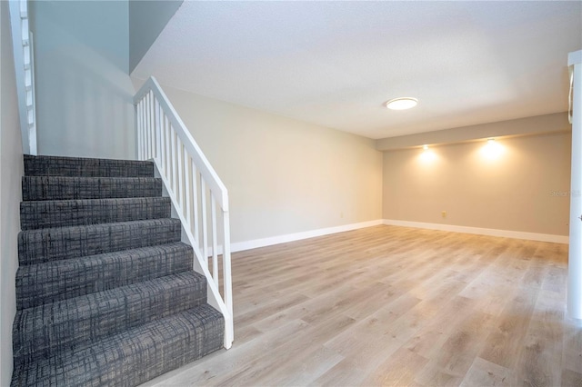 stairway featuring wood-type flooring