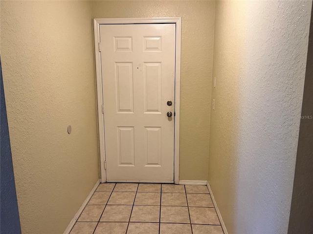 doorway to outside featuring light tile floors