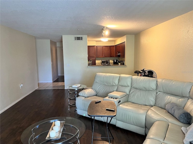 living room with hardwood / wood-style floors and a textured ceiling