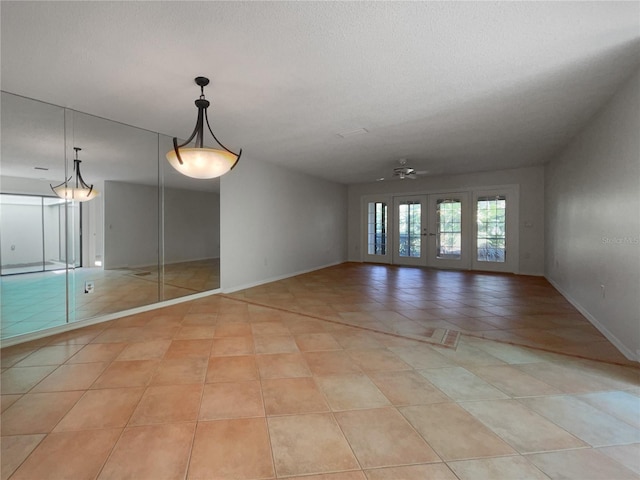 unfurnished room featuring ceiling fan and light tile floors