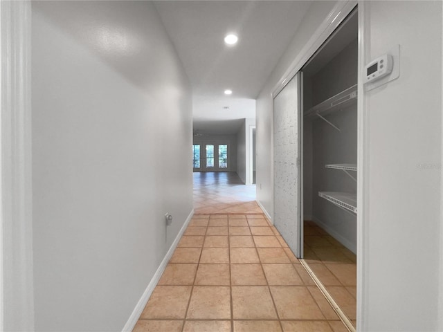 hall featuring light tile floors