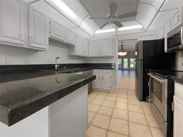 kitchen featuring ceiling fan, light tile floors, sink, stainless steel appliances, and white cabinetry