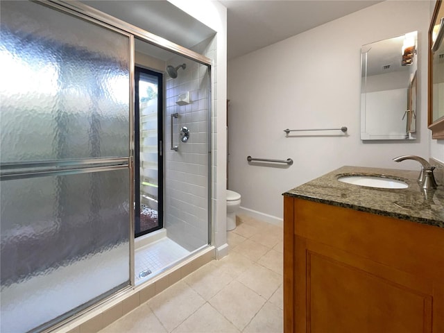 bathroom with an enclosed shower, vanity, tile flooring, and toilet