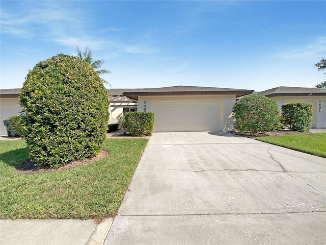 view of front of property with a garage and a front yard