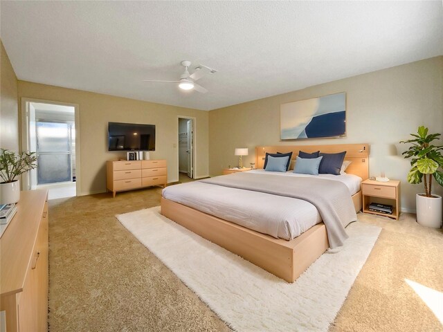 carpeted bedroom with ceiling fan, a textured ceiling, and connected bathroom