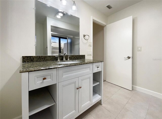 bathroom with tile patterned floors and vanity