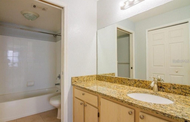 bathroom with visible vents, toilet, washtub / shower combination, vanity, and tile patterned flooring