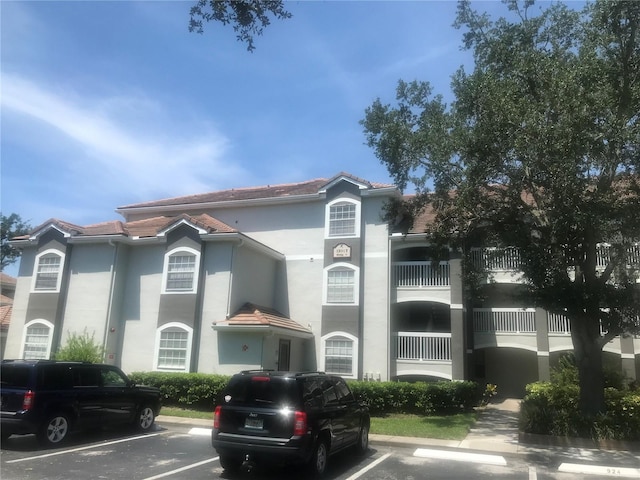 view of property featuring uncovered parking