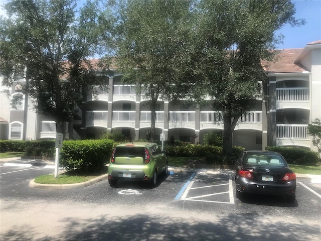 view of building exterior with uncovered parking