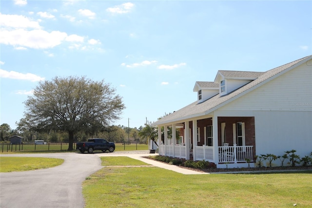 view of yard featuring covered porch