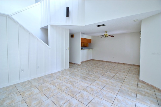 unfurnished living room with light tile patterned floors and ceiling fan