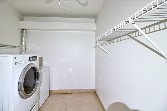 clothes washing area with washer and dryer, light tile patterned flooring, and ceiling fan