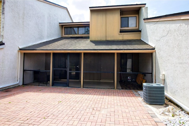 back of property featuring a patio, a sunroom, and central air condition unit