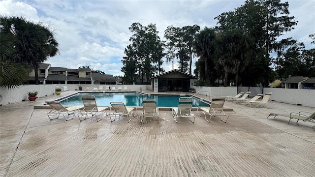 view of swimming pool featuring a patio area