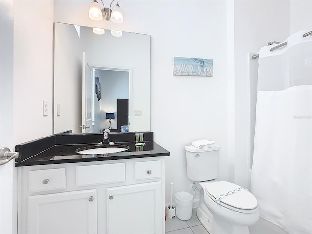 bathroom with an inviting chandelier, toilet, vanity, and tile flooring