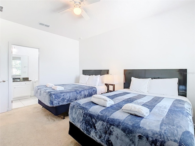 carpeted bedroom featuring ensuite bathroom and ceiling fan