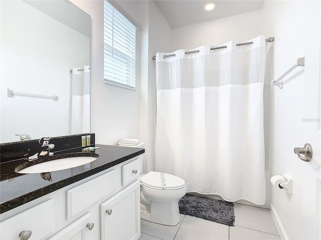 bathroom with toilet, tile floors, and oversized vanity