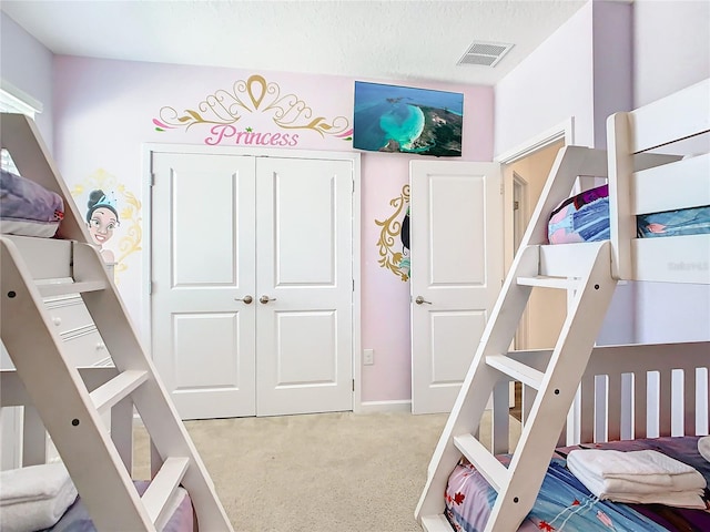 bedroom with a closet and light colored carpet