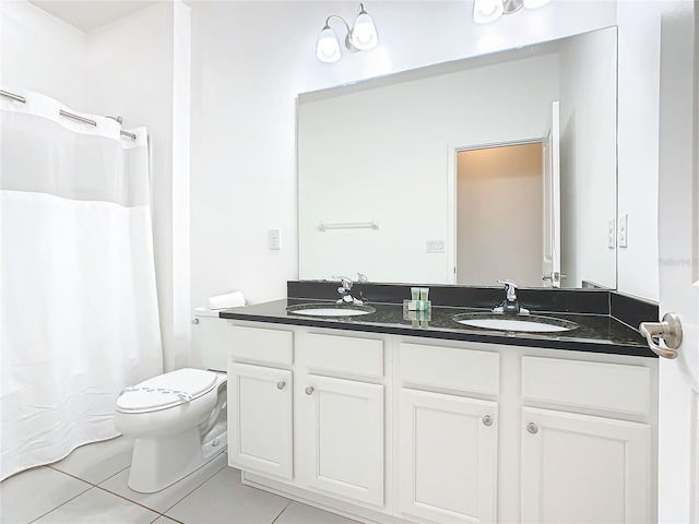 bathroom with toilet, a notable chandelier, oversized vanity, dual sinks, and tile floors