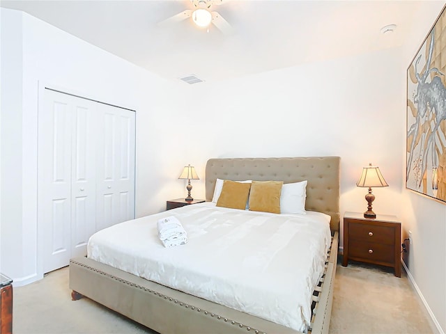 carpeted bedroom featuring a closet and ceiling fan