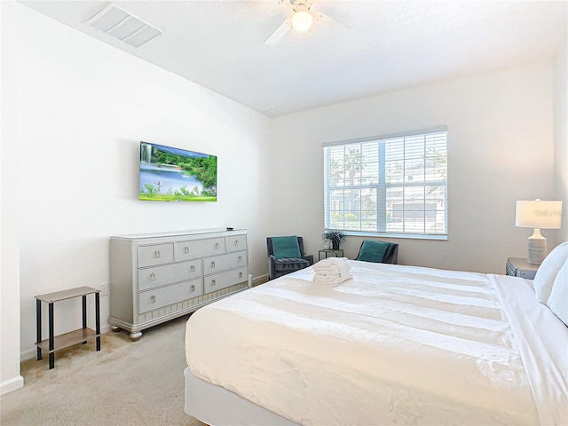 bedroom featuring light colored carpet and ceiling fan