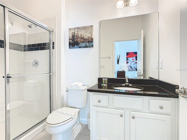 bathroom featuring an enclosed shower, vanity, tile flooring, and toilet