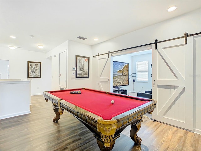 game room with a barn door, billiards, and wood-type flooring