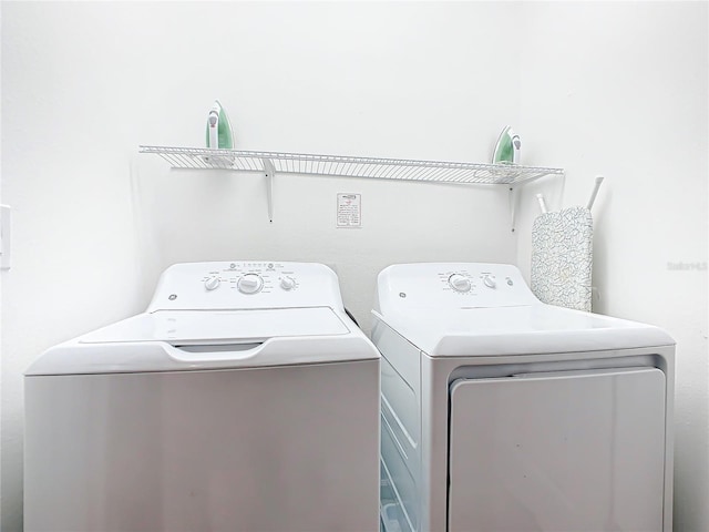 clothes washing area featuring washer and dryer