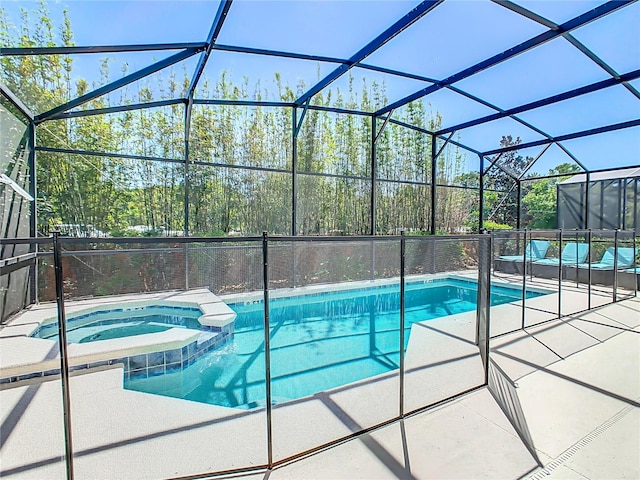 view of swimming pool with an in ground hot tub, glass enclosure, and a patio