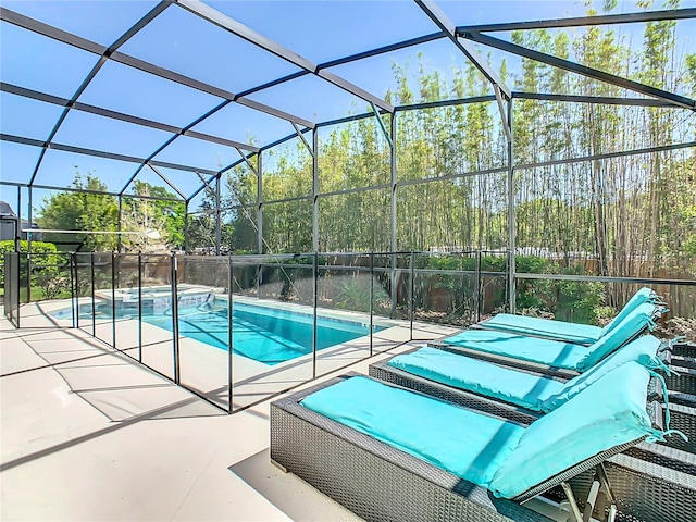 view of pool with a patio area and a lanai